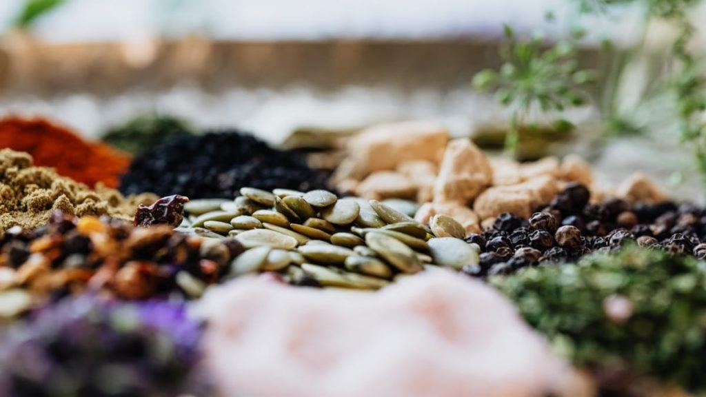 Close-up of assorted spices and seeds showcasing culinary diversity.